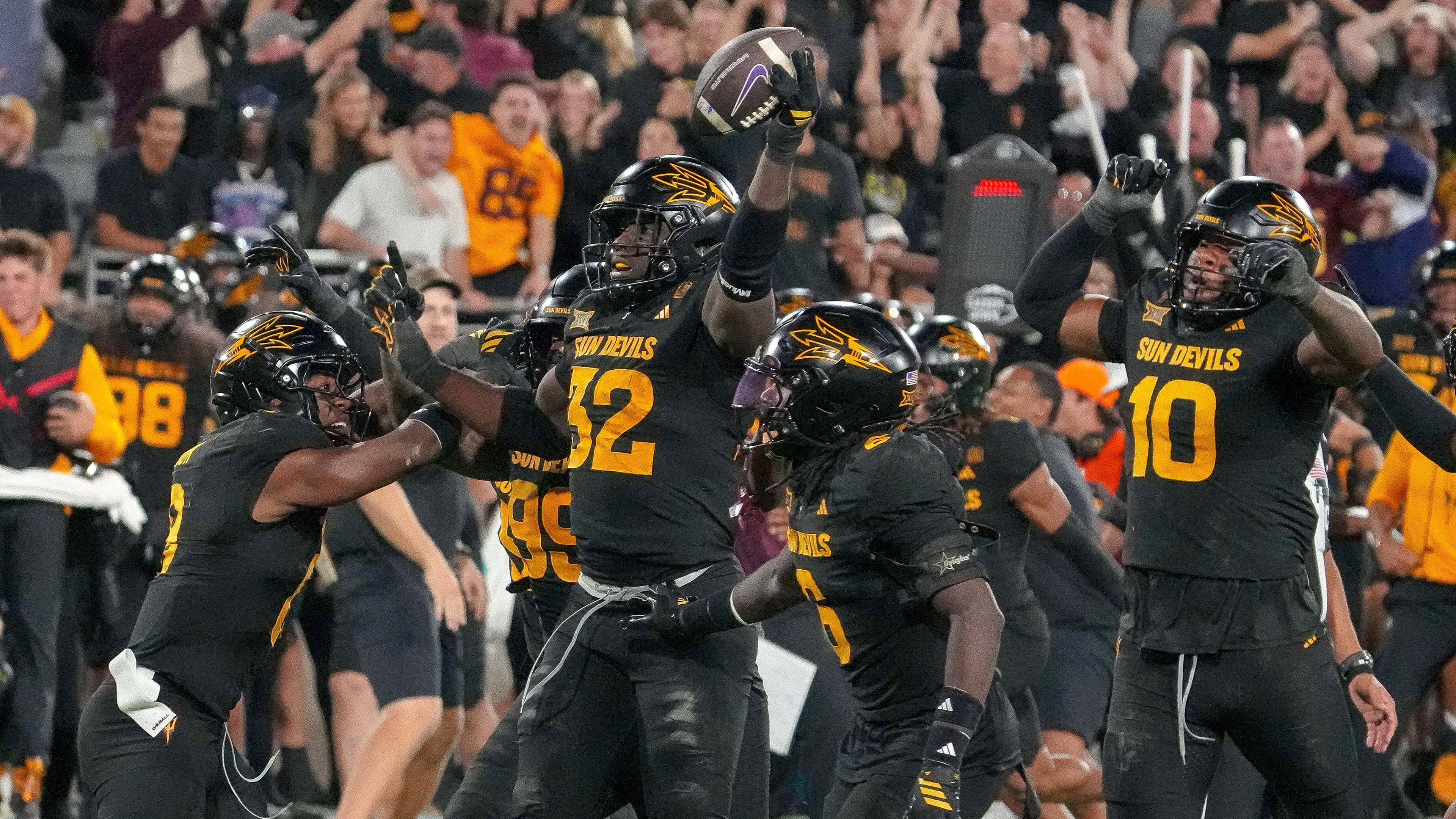Surrounded by teammates Arizona State Sun Devils defensive lineman Prince Dorbah (32) celebrates his strip sack from TCU Horned Frogs quarterback Josh Hoover (10) during the second half of an NCAA college football game Friday, Sept. 26, 2025, in Tempe, Ariz. (AP Photo/Darryl Webb)