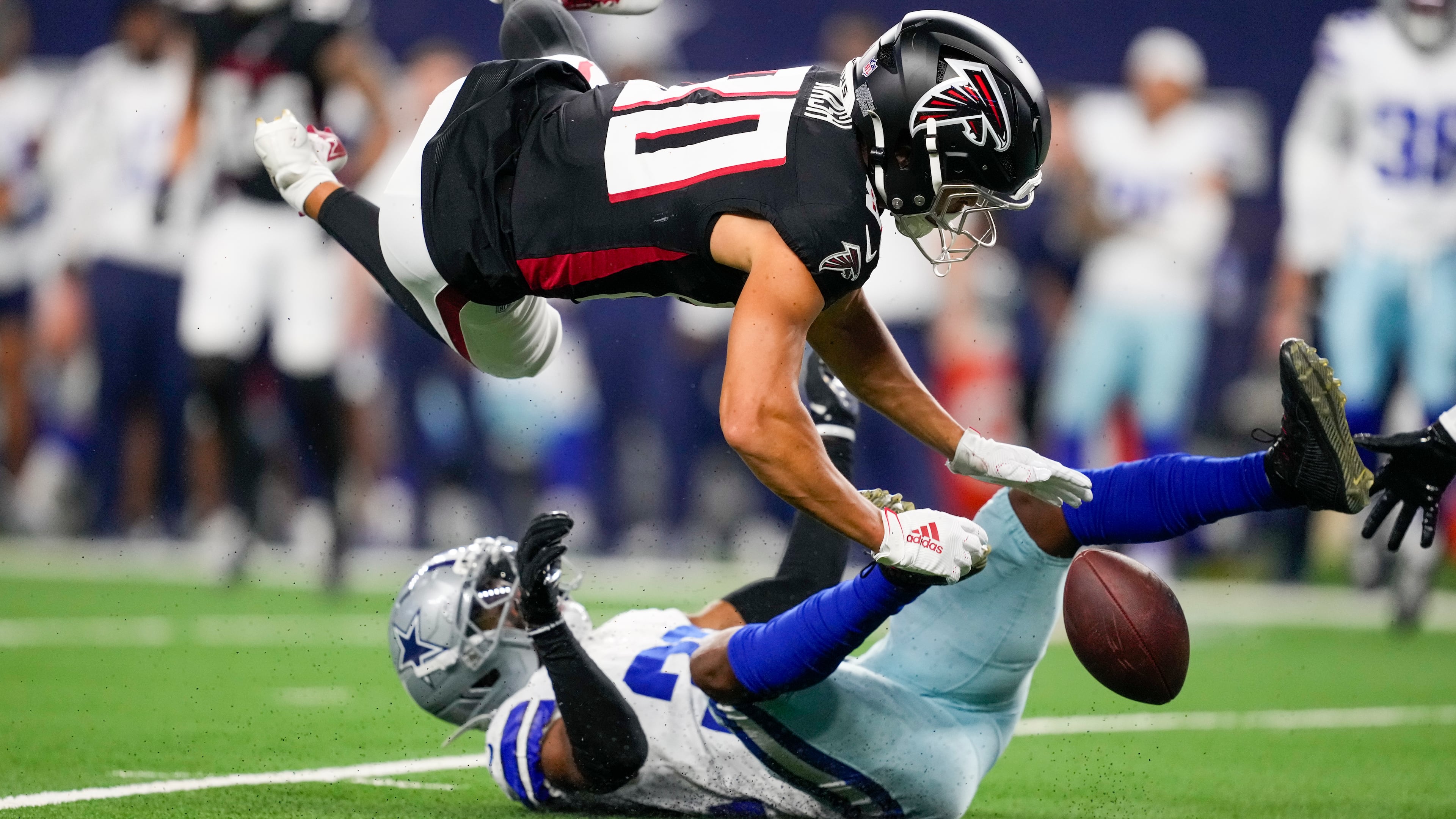 Dallas Cowboys cornerback Troy Pride Jr., bottom, breaks up a pass intended for Atlanta Falcons wide receiver Nick Nash during the first half of a preseason NFL football game Friday, Aug. 22, 2025, in Arlington, Texas. (AP Photo/Tony Gutierrez)