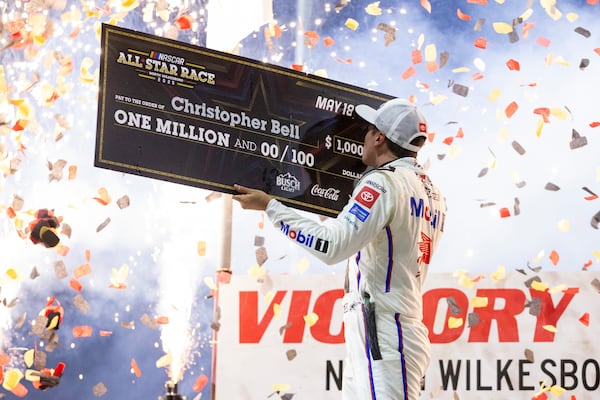 Christopher Bell celebrates after winning the NASCAR All-Star auto race Sunday, May 18, 2025, in North Wilkesboro, N.C. (AP Photo/Scott Kinser)