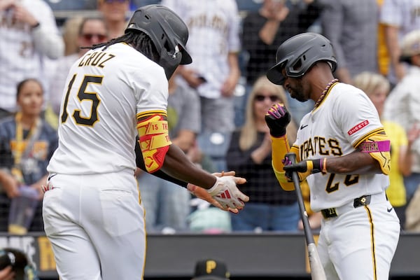 Pittsburgh Pirates' Oneil Cruz, left, is greeted by Andrew McCutchen, right, after hitting a home run during the third inning of a baseball game against the Milwaukee Brewers, Sunday, May 25, 2025, in Pittsburgh. (AP Photo/Matt Freed)