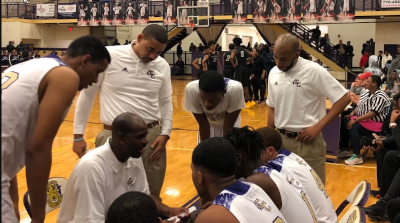 East Cowta’s boys basketball team, coached by Royal Maxwell (center), is 19-1 and ranked No. 3 in Class AAAAAAA after victories over state-powers Wheeler and Pebblebrook. East Coweta has not made the state playoffs since 2005 nor won a state-playoff game since 1964.