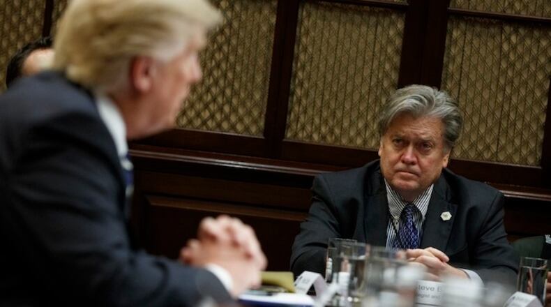 White House Chief Strategist Steve Bannon listens at right as President Donald Trump speaks during a meeting on cyber security in the Roosevelt Room of the White House in Washington, Tuesday, Jan. 31, 2017. (AP Photo/Evan Vucci)