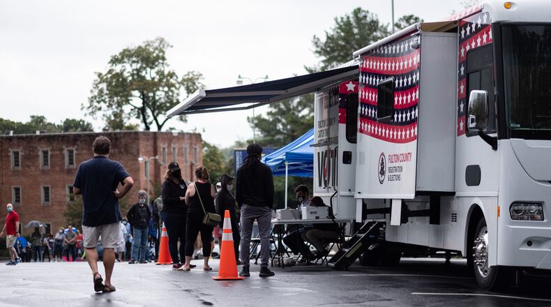 One of Fulton County’s two mobile voting stations sits in the parking lot of Morningside Baptist Church on Monday morning Oct. 12, 2020 for the first day of early voting. The polling place was set to open at 8 a.m., but by 10 a.m. they had only been able to process one voter due to technology issues. (Ben Gray for The Atlanta Journal-Constitution)