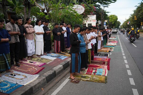 Muslims perform an Eid al-Fitr prayer that marks the end of the holy fasting month of Ramadan, on a street in Jakarta, Indonesia, Monday, March 31, 2025. (AP Photo/Dita Alangkara)