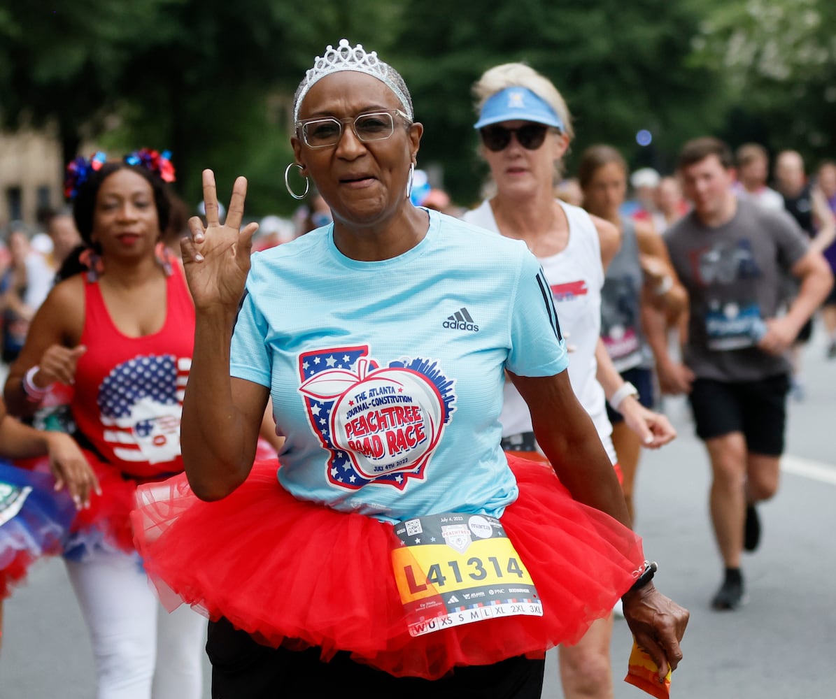 Costumed runners on Peachtree Street during the 54th running of The Atlanta Journal-Constitution Peachtree Road Race on Tuesday, July 4th, 2023.   (Miguel Martinez / Miguel.Martinezjimenez@ajc.com)