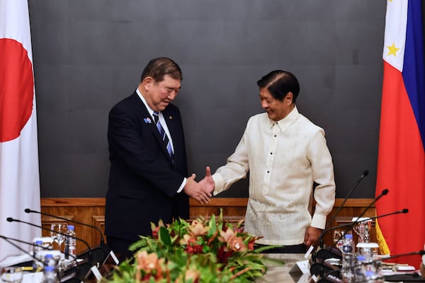 Japan's Prime Minister Shigeru Ishiba, left, and Philippines President Ferdinand Marcos Jr. shake hands before the start of a bilateral meeting at Malacanang Palace in Manila, Philippines Tuesday, April 29, 2025. (Rolex Dela Pena/Pool Photo via AP)