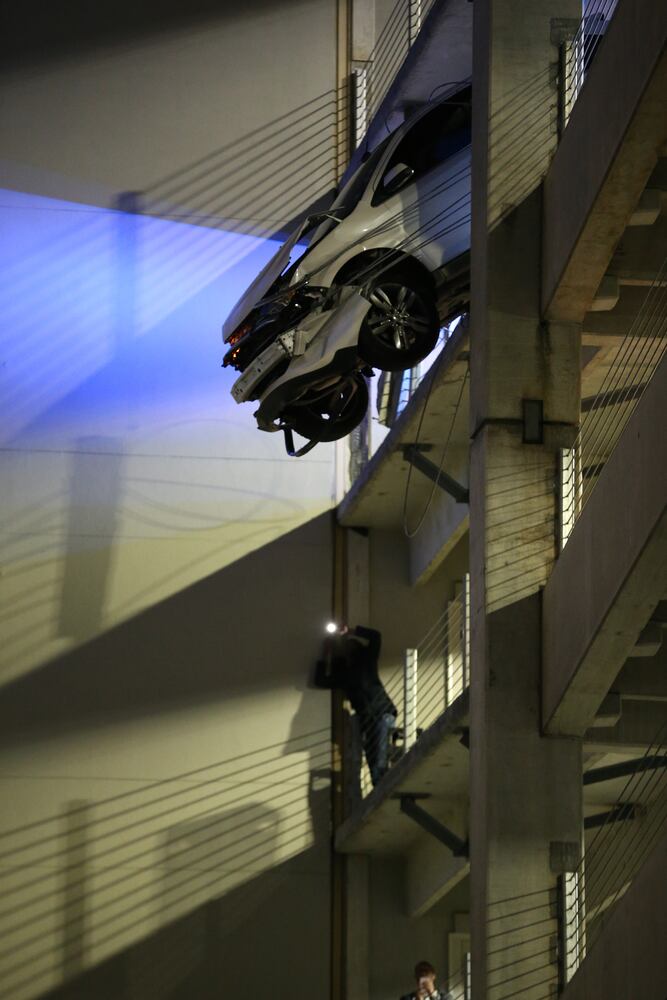 Car dangles from parking deck
