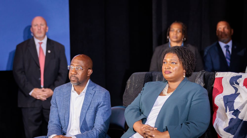 Democratic U.S. Sen Raphael Warnock and gubernatorial candidate Stacey Abrams listen to former President Barack Obama speak Oct. 28 at a rally for the party's candidates. Warnock and Abrams took different approaches to President Joe Biden's administration during their campaigns, with Warnock keeping the president at arm's length while Abrams maintained strong support for him. Now that she has lost the race for governor, a position in Biden's Cabinet could be a next step. (Arvin Temkar/The Atlanta Journal-Constitution/TNS)