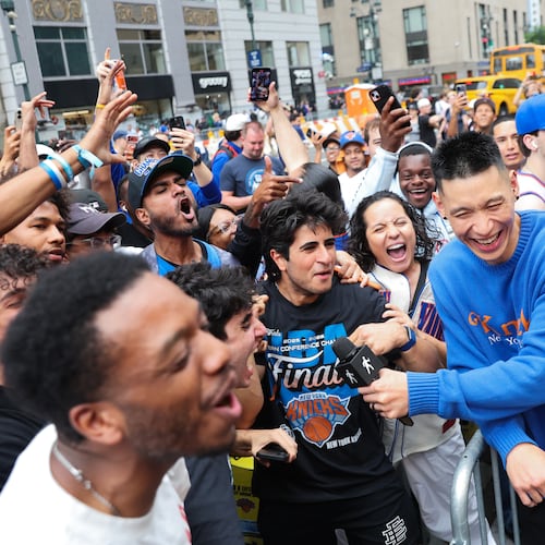 Former New York Knicks player Jeremy Lin, right, interviews Knicks fans outside of Madison Square Garden ahead of Game 4 of the NBA Finals between the Knicks and San Antonio Spurs, Wednesday, June 10, 2026, in New York. (AP Photo/Heather Khalifa)