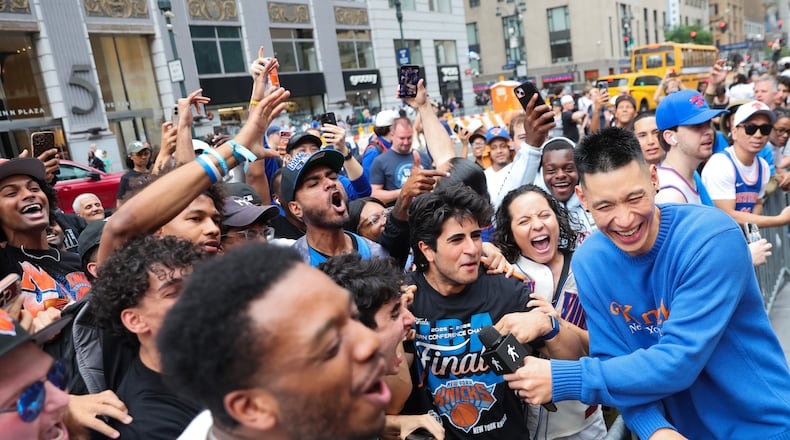 Former New York Knicks player Jeremy Lin, right, interviews Knicks fans outside of Madison Square Garden ahead of Game 4 of the NBA Finals between the Knicks and San Antonio Spurs, Wednesday, June 10, 2026, in New York. (AP Photo/Heather Khalifa)