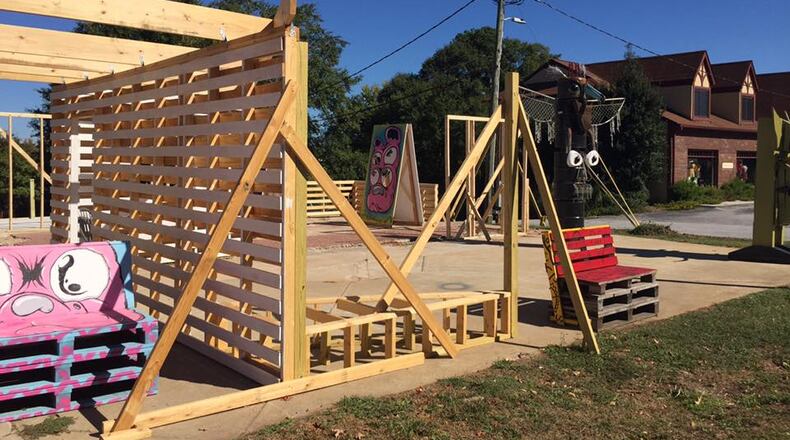 This is a temporary pop-up park called the Art Lot, still under construction when this photo taken last fall. The Art Lot sits on the former site of the Avondale Pizza Cafe, which is part of the four acres owned by Avondale Estates just west of the Tudor Village. By September the city hopes to have an actual development design for the four acres to take to a developer along with the potential costs. Bill Banks file photo for the AJC