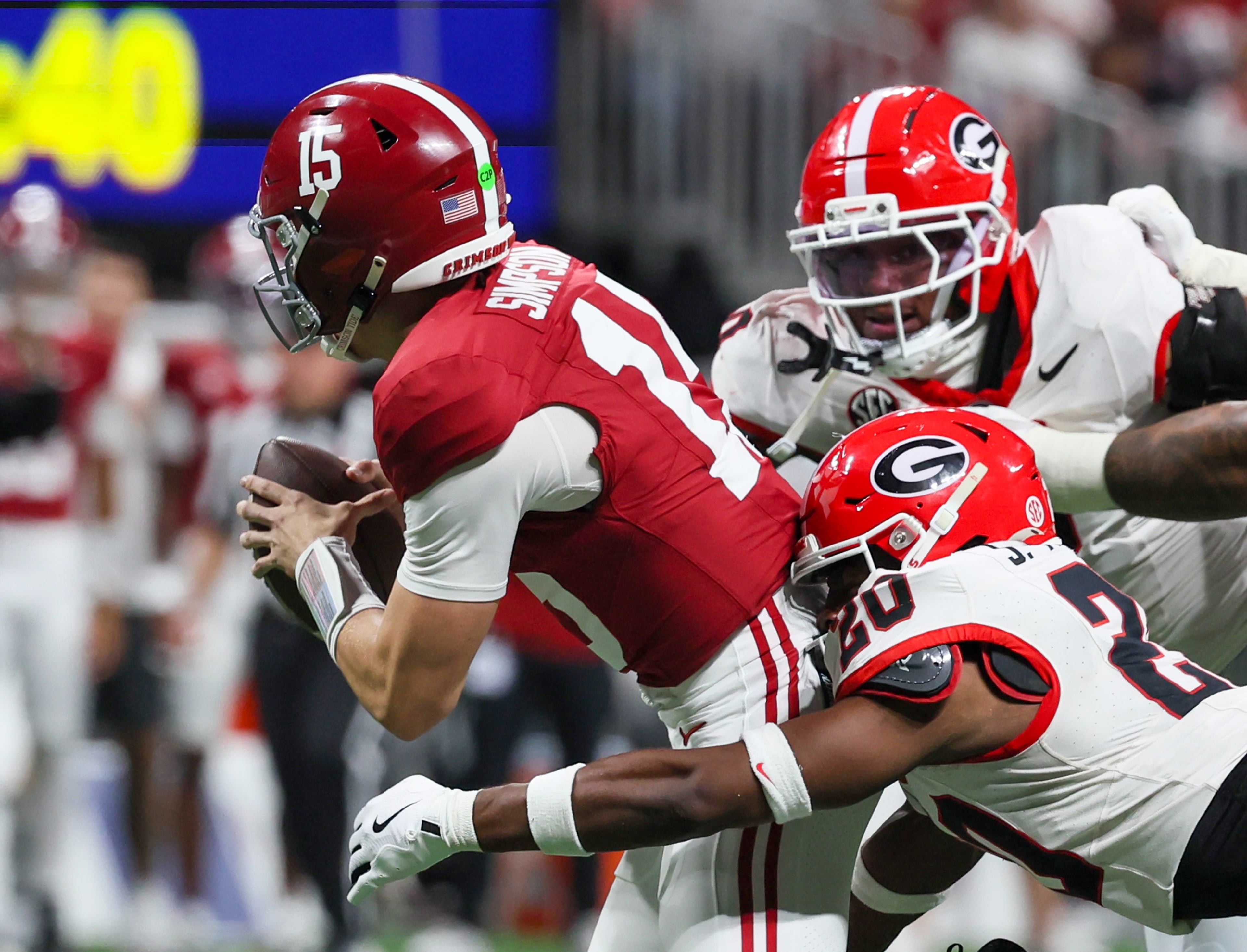 Alabama quarterback Ty Simpson (15) is sacked by Georgia defensive back Jacorey Thomas (20) during the third quarter of the SEC Championship game at Mercedes-Benz Stadium, Saturday, Dec. 6, 2025, in Atlanta. (Jason Getz / AJC)