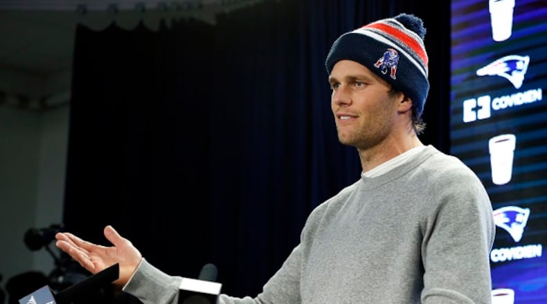 In this Jan. 22, 2015, file photo, New England Patriots quarterback Tom Brady speaks at a news conference about the NFL investigation into deflated footballs, in Foxborough, Mass. An NFL investigation has found that New England Patriots employees likely deflated footballs and that Brady was “at least generally aware” of the rules violations. (AP Photo/Elise Amendola)