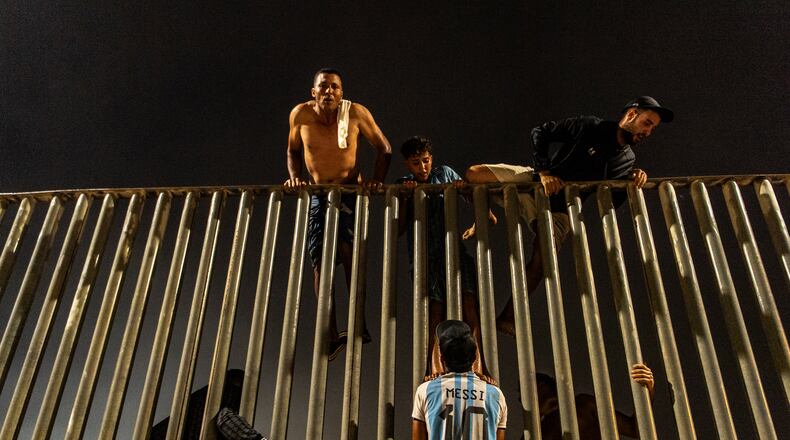 Migrants try to cross from Morocco into the Spanish enclave of Ceuta, Friday, July 31, 2026. (AP Photo/Antonio Sempere)