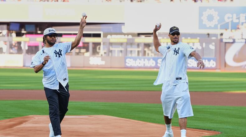 New York Knicks' Josh Hart, right, and Jalen Brunson throw out a ceremonial first pitch before a baseball game between the Chicago White Sox and the New York Yankees Wednesday, June 17, 2026, in New York. (AP Photo/Frank Franklin II)