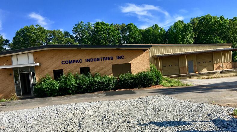 A portion of the six-acre site on Talley Street where the new Decatur school will get built. Most of the summer will be spent demoslishing several old commercial buildings and houses on the site, including this office building and warehouse. The school’s scheduled to open in August, 2019. Bill Banks for the AJC