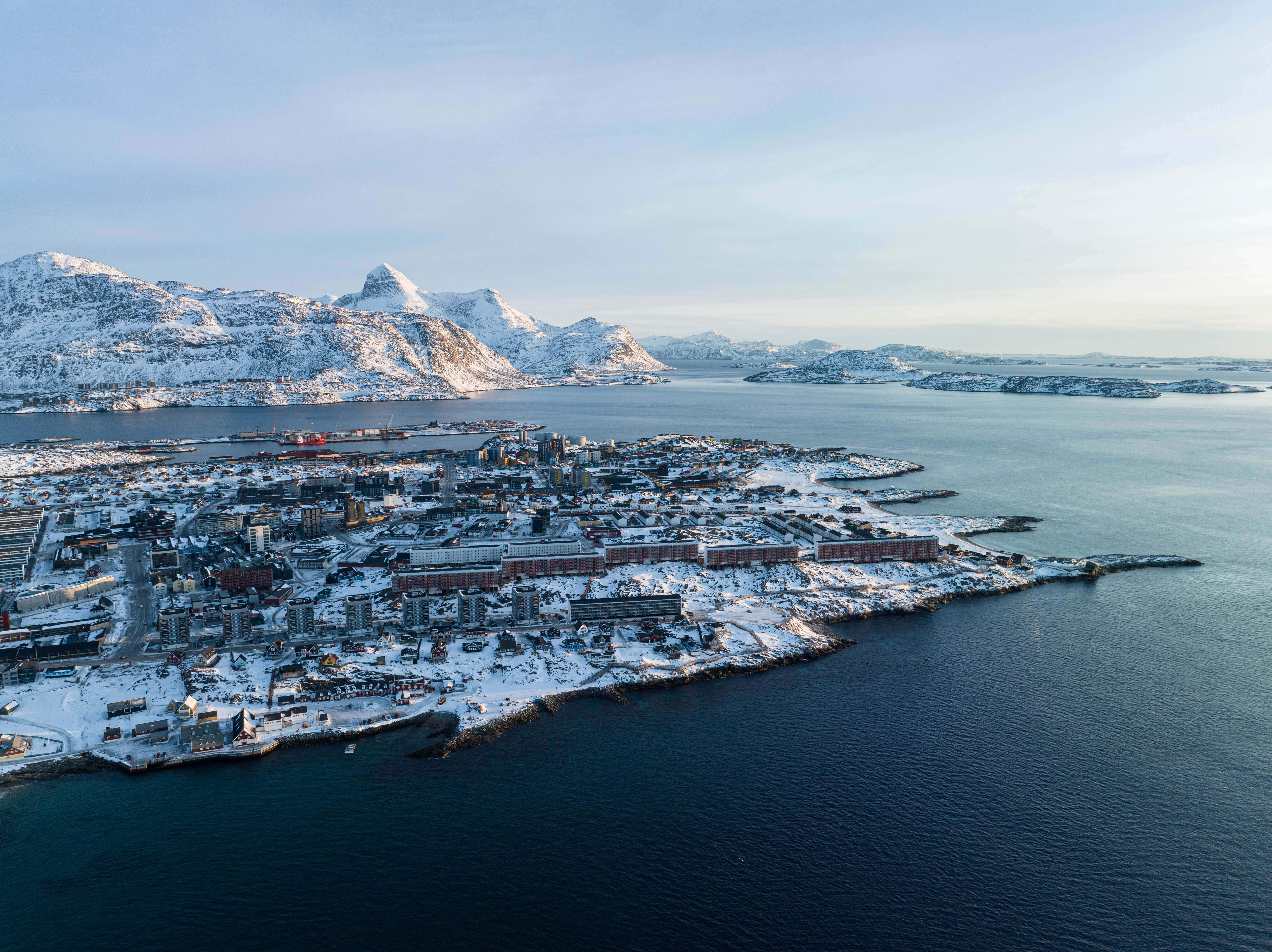 Houses are seen near the coast of a sea inlet of Nuuk, Greenland, on Sunday, Jan. 25, 2026. (AP Photo/Evgeniy Maloletka)
