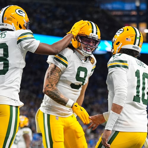 Green Bay Packers wide receiver Christian Watson (9) celebrates a touchdown with wide receiver Dontayvion Wicks (13) and quarterback Jordan Love (10) against the Detroit Lions during the second half an NFL football game in Detroit, Thursday, Nov. 27, 2025. (AP Photo/Ryan Sun)