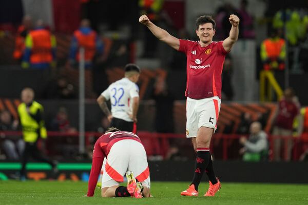 Manchester United's Harry Maguire celebrates besides Luke Shaw after the Europa League quarter final second leg soccer match between Manchester United and Olympique Lyon in Manchester, Britain, Thursday, April 17, 2025. (AP Photo/Jon Super)