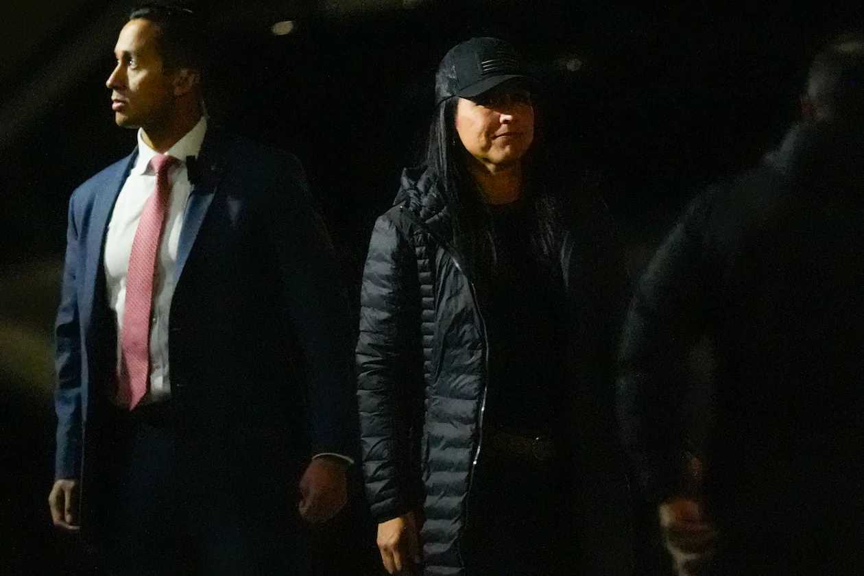 Director of National Intelligence Tulsi Gabbard (right) enters the Fulton County Election Hub and Operation Center as the FBI takes 2020 election ballots in Union City, Ga., on Wednesday. (Mike Stewart/AP)