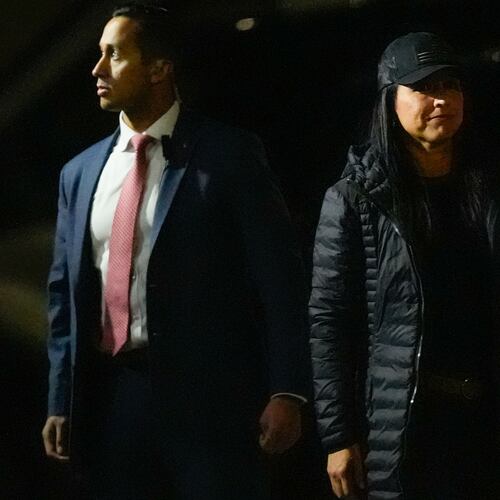 Director of National Intelligence Tulsi Gabbard (right) enters the Fulton County Election Hub and Operation Center as the FBI takes 2020 election ballots in Union City, Ga., on Wednesday. (Mike Stewart/AP)
