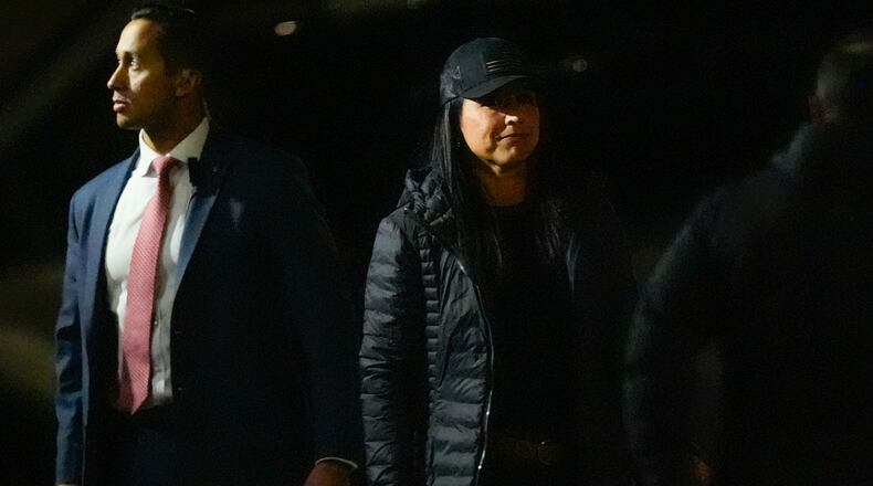 Director of National Intelligence Tulsi Gabbard (right) enters the Fulton County Election Hub and Operation Center as the FBI takes 2020 election ballots in Union City, Ga., on Wednesday. (Mike Stewart/AP)