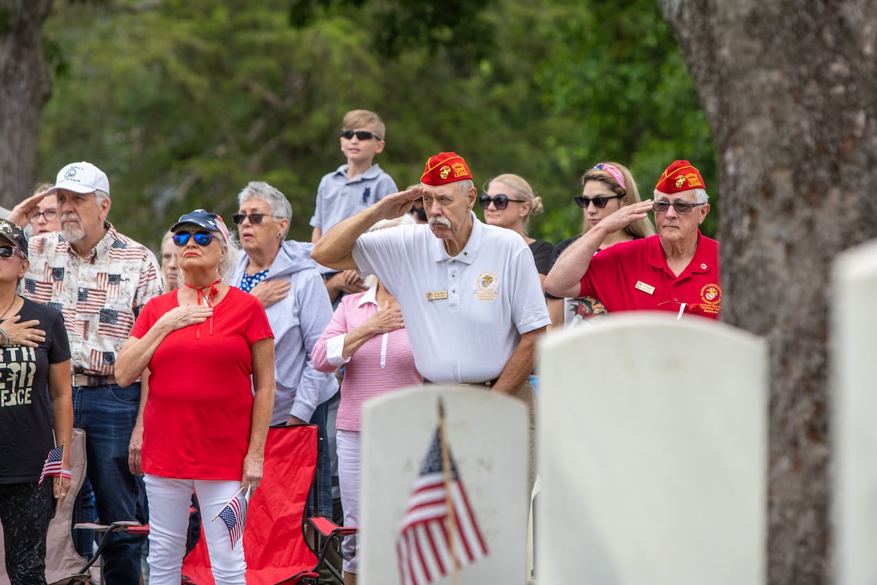 Marine veteran Doug Tasse, white shirt, second from right, salutes during the Pledge of Allegiance the 77th annual Memorial Day Observance at the Marietta National Cemetery on Monday, May 29, 2003. (Jenni Girtman for The Atlanta Journal-Constitution)