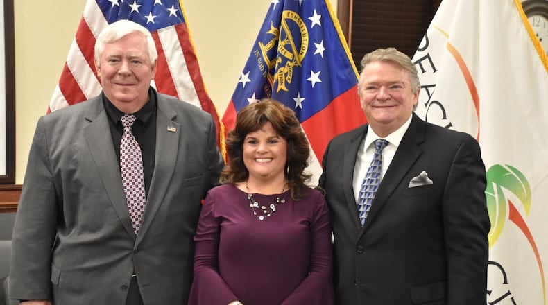 Peachtree City council members Terry Ernst (left) and Kevin Madden (right) were sworn into office along with re-elected Mayor Vanessa Fleisch. Jill Howard Church for the AJC
