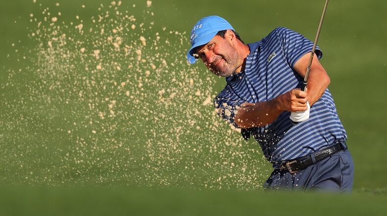 Jose Maria Olazabal hits his sand shot from the bunker to the 10th green during Thursday’s pro-am for the Mitsubishi Electric Classic at TPC Sugarloaf in Duluth. (Curtis Compton/ccompton@ajc.com)
