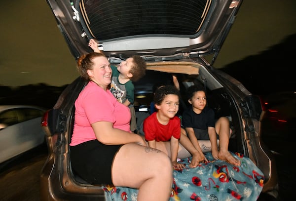Quintis Johnson and her children (from left) Zaki, 3, Zhier, 5 and Zyvon, 6, enjoy watching "Lilo & Stitch" from their SUV at Starlight Drive-In Theatre, Friday, June 13, 2025, in Atlanta. (Hyosub Shin/AJC)