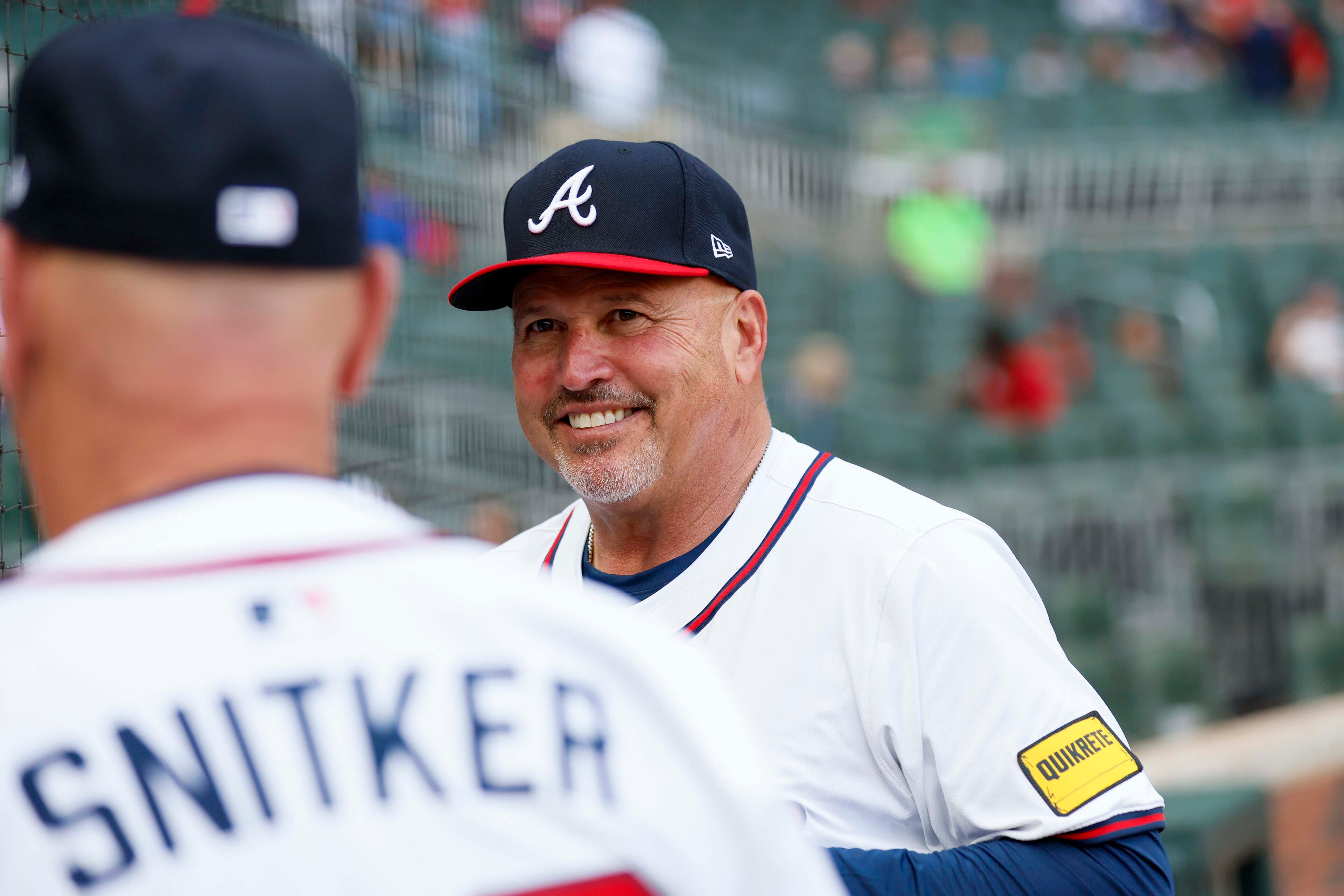 Atlanta Braves third base coach Fredi Gonzalez (86) smiles as he talks with Atlanta Braves manager Brian Snitker (43) before the game between the Atlanta Braves and the Arizona Diamondbacks at Truist Park on Tuesday, June 3, 2025, in Atlanta.
(Miguel Martinez/ AJC)