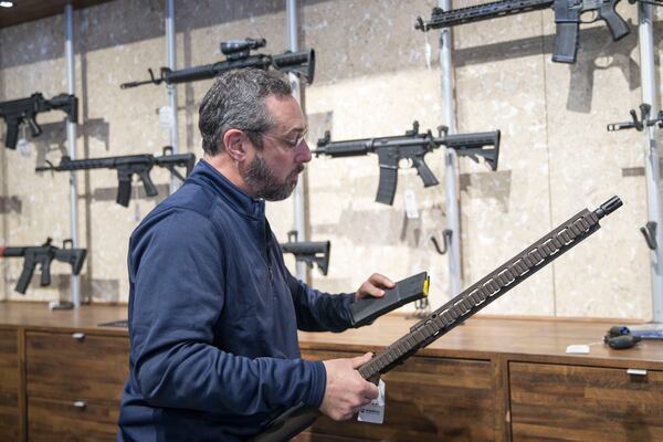 02/19/2018 -- Atlanta, GA - Stoddard's Range and Guns co-owner Ken Baye handles a Daniel Defense M4V1 behind the counter of his Midtown-Atlanta store, Monday, February 19, 2018. ALYSSA POINTER/ALYSSA.POINTER@AJC.COM