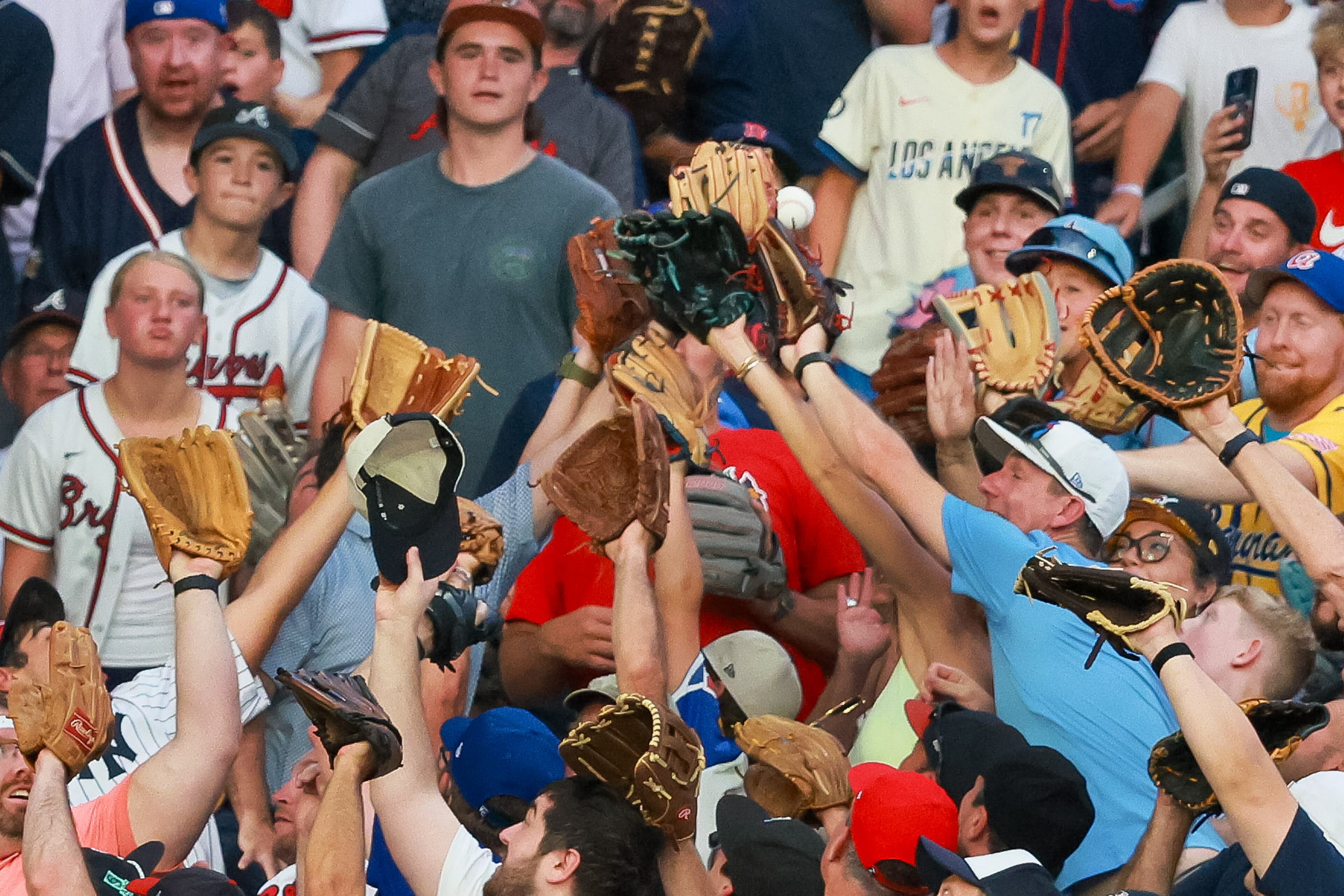 Fans try to field a home run by Tampa Bay Rays third baseman Junior Caminero during the MLB Home Run Derby as part of the All-Star Game festivities on Monday, July 14, 2025 at Truist Park in Atlanta. Jason Getz / AJC