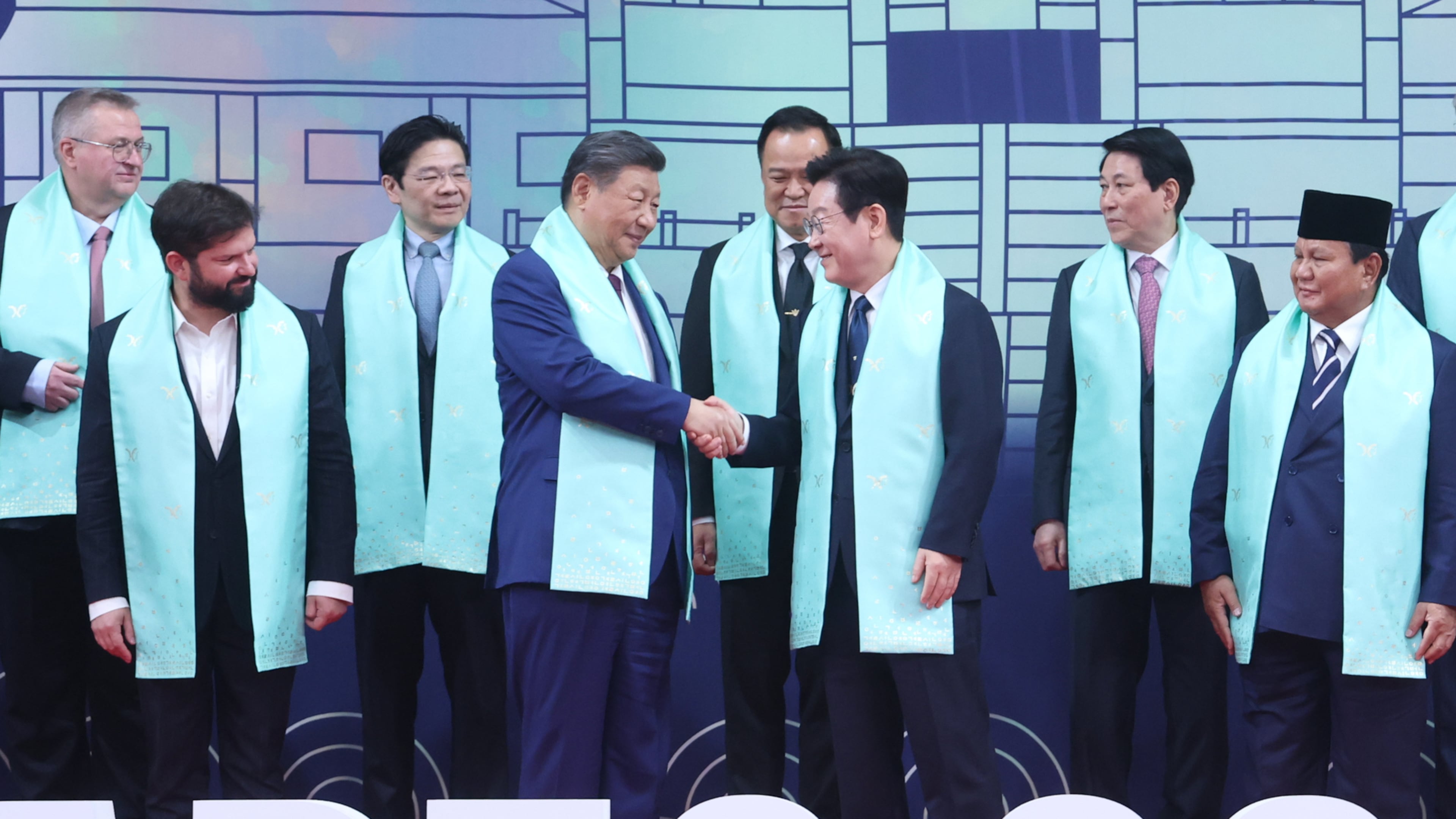 Chinese President Xi Jinping, center left, and South Korean President Lee Jae Myung, center right, shake hands after a group photo at the Asia-Pacific Economic Cooperation (APEC) Economic Leaders' Meeting in Gyeongju, South Korea, Saturday, Nov. 1, 2025. (Yonhap via AP)
