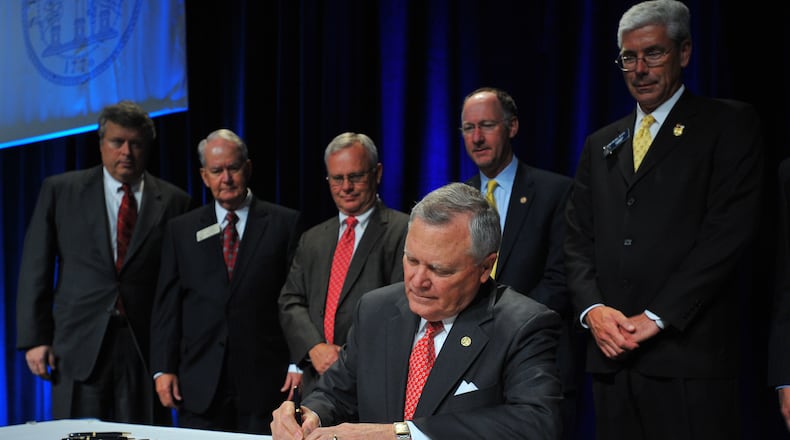 April 19, 2012: College Park, GA: Gov. Nathan Deal signs a bill that will overhaul the state's tax code Thursday April 19, 2012. The signing took place during the Governor's Award Luncheon, part of Georgia's Manufacturing Appreciation Week. Brant Sanderlin bsanderlin@ajc.com