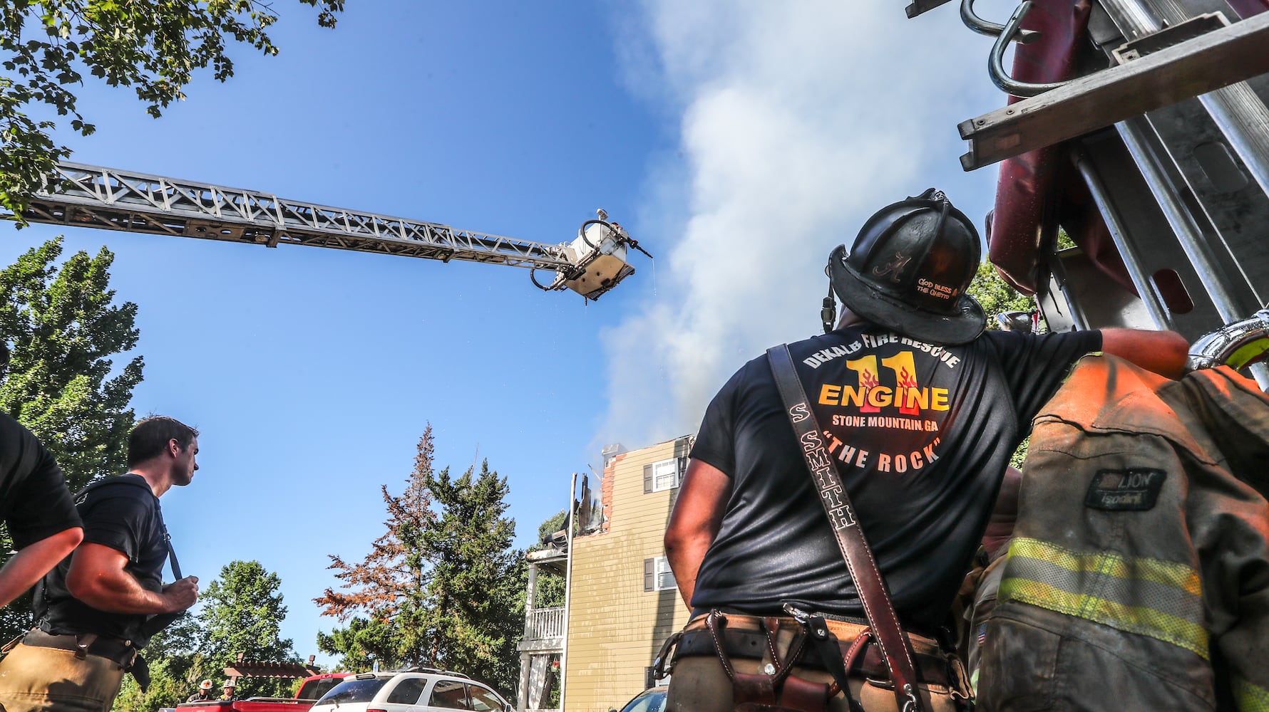 July 18, 2022 DeKalb County: All residents of a Brookhaven apartment building were able to escape their homes safely when a massive blaze broke out early Monday morning, July 18, 2022. No injuries were reported in the fire at the Evergreen Lenox Park apartments, which sent huge flames and smoke high into the air above nearby Roxboro and North Druid Hills roads at the start of the morning commute. Everyone inside the building evacuated before the first crews arrived about 6:30 a.m., thanks in large part to the effort of one man. Yusuf Thorne was on his way into work when he heard a subtle cracking sound and spotted the fire coming from an apartment on the third floor. Thorne said he called 911, connected with a dispatcher, and immediately hung up to begin knocking on his neighbors’ doors. He escorted one woman to safety and went back again to try to wake another neighbor. “He eventually came out,” Thorne said. “I was going to have to kick the door down if they didn’t get out of there.” Thorne said he had to continue knocking on doors as the fire spread. According to fire Capt. Jaeson Daniels, the flames reached an attic space and eventually destroyed several third-floor units. “It started on the third floor so the fire didn’t have very far to travel to get to the attic, really saving the apartments on the bottom from fire damage,” Daniels said. “But unfortunately, the top apartments had severe fire damage.” He estimates about 18 families will lose their homes and need the assistance of the American Red Cross for temporary lodging and other emergency needs. Fire crews dug through the debris Monday morning to learn the extent of the damage. Investigators have not determined the fire’s cause or exact origin. (John Spink / John.Spink@ajc.com)

