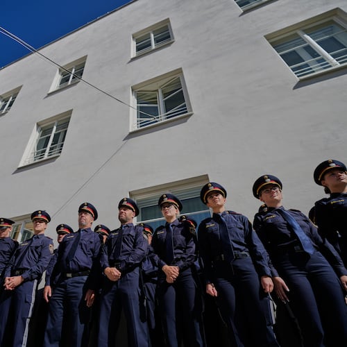 Austrian police officers stand in front of a new police station which is located in Adolf Hitler's birth house in Braunau am Inn, Austria, Wednesday, July 22, 2026. (AP Photo/Matthias Schrader)
