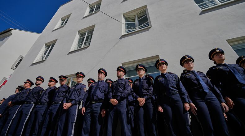 Austrian police officers stand in front of a new police station which is located in Adolf Hitler's birth house in Braunau am Inn, Austria, Wednesday, July 22, 2026. (AP Photo/Matthias Schrader)