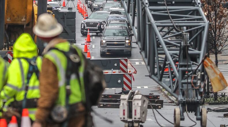 Traffic backs up on Spring Street where a construction crane is blocking the road and causing major traffic headaches. (John Spink / John.Spink@ajc.com)