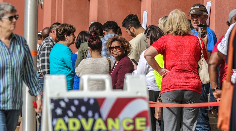 People lined up for early voting at the Cobb County West Park Government Center in Marietta on Oct. 18, 2018. JOHN SPINK / JSPINK@AJC.COM