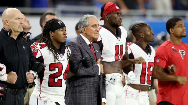 DETROIT, MI - SEPTEMBER 024: Atlanta Falcons owner Arthur Blank joins arms with his players during the playing of the national anthem prior to the game against the Detroit Lions at Ford Field on September 24, 2017 in Detroit, Michigan. (Photo by Leon Halip/Getty Images)