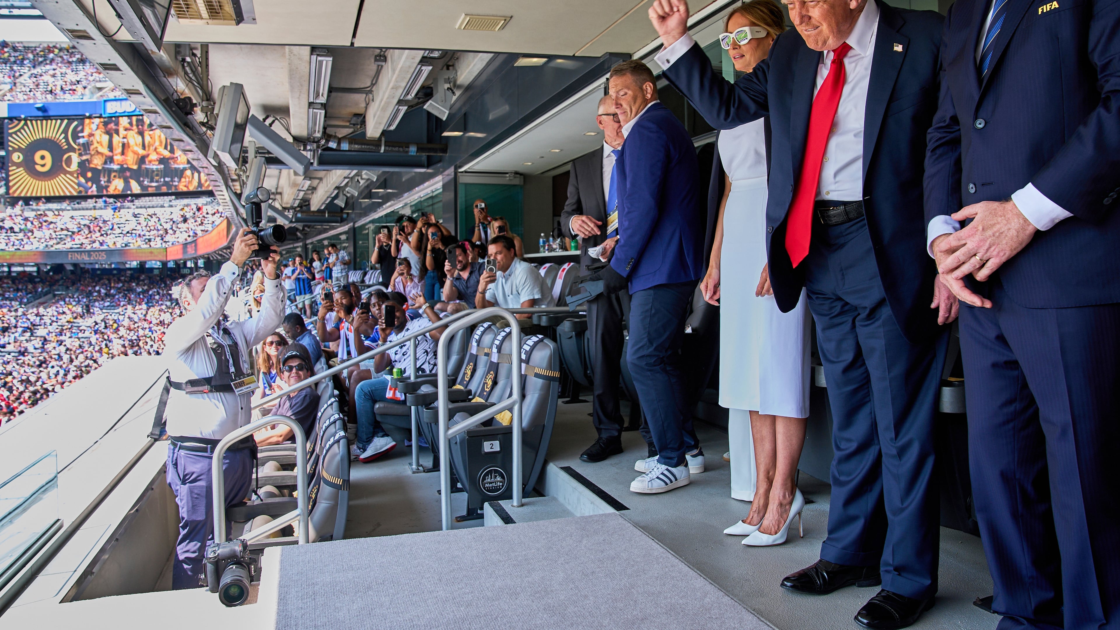 FILE - President Donald Trump, from right, pumps his fist as he and first lady Melania Trump look to the crowd while attending the Club World Cup final soccer match, at MetLife Stadium in East Rutherford, N.J., July 13, 2025. (AP Photo/Jacquelyn Martin, File)