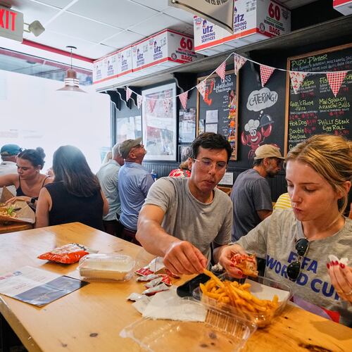People wearing World Cup shirts taste sandwiches at Pauli's sandwich shop in the North End of Boston, Wednesday, June 24, 2026. (AP Photo/Martin Meissner)