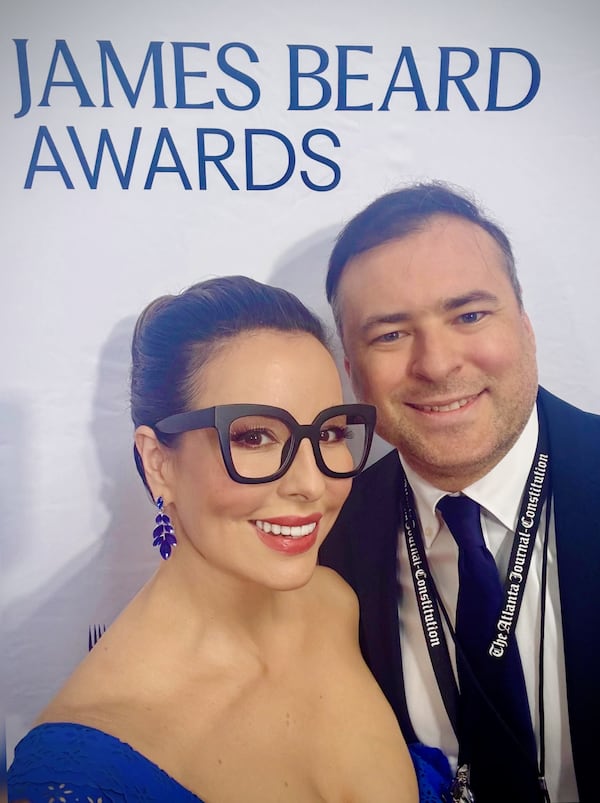 AJC senior editor of Food & Dining Monti Carlo and AJC Restaurant Critic Henri Hollis take a selfie on the red carpet at the 2026 James Beard Awards.