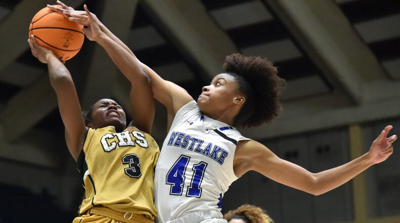 Westlake's Rhyann Wilson blocks a shot by Carrollton's De'Mauri Flournoy during the 2021 GHSA State Basketball Class AAAAAA Girls Championship game. (Hyosub Shin / Hyosub.Shin@ajc.com)