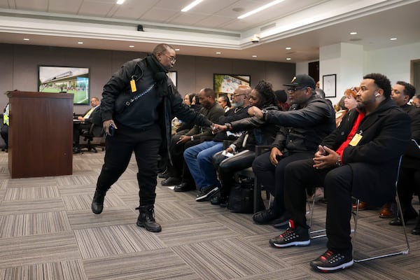MARTA bus driver Shaunty Locklear, left, gets a fist bump from fellow drivers after Locklear asked the board of directors for safety changes following the shooting of the late MARTA bus driver Leroy Ramos during a public comment portion at the MARTA headquarters, Thursday, Jan. 9, 2025, in Atlanta. Ramos was killed at the Decatur bus station on Swanton Way around 6:30 p.m. Friday, Jan. 3rd. MARTA has said he was shot during a dispute over the $2.50 fare. (Jason Getz/AJC)
