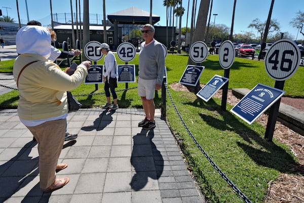 Fans pose for photos in Monument Park at Geroge M. Steinbrenner Field during a spring training baseball game between the Minnesota Twins and the New York Yankees, Thursday, March 6, 2025, in Tampa, Fla. (AP Photo/Chris O'Meara)