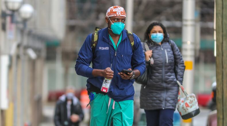 Dr. Eliel Arrey, a surgeon, is shown arriving for work at Grady Memorial Hospital on Tuesday.  Grady, the site where both the state's top health official and many of Atlanta's poor have been vaccinated against COVID-19, recently checked on its weekly allocation of coronavirus vaccination doses to find it would get none at all.  A round of shock and pleading shook loose 220 doses from the state's overall allocation. (PHOTO by John Spink / John.Spink@ajc.com)