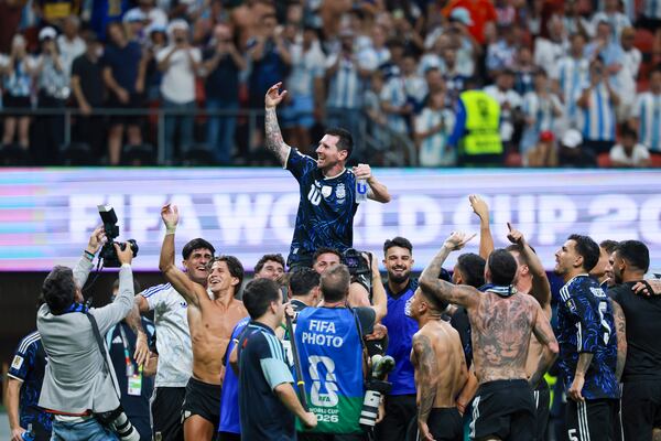 Argentina teammates lift Lionel Messi on their shoulders after beating England in the FIFA World Cup Semifinal match July 15, 2026. (Jason Getz/AJC)