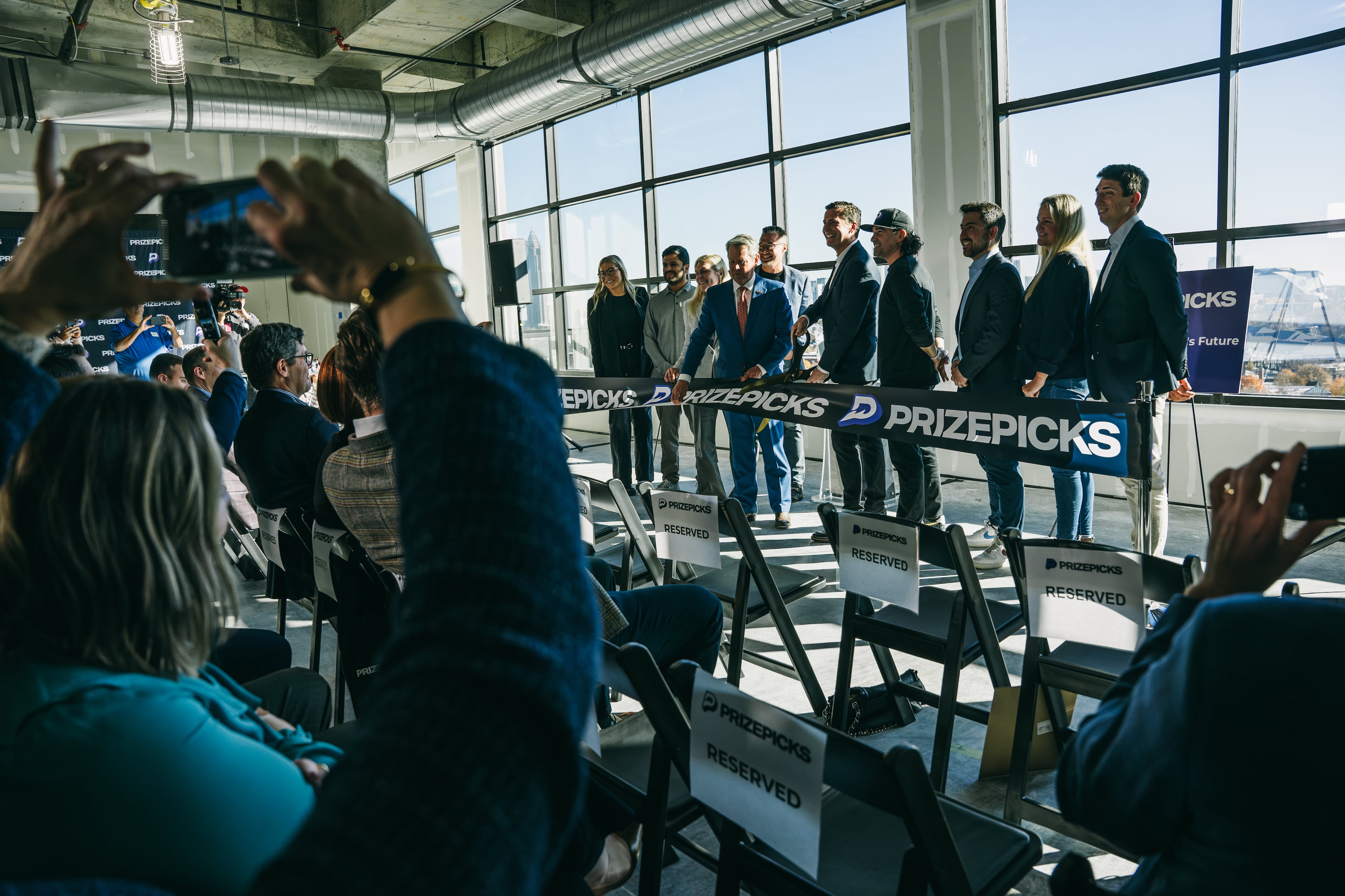 Governor Brian Kemp and speakers cut the ribbon at the PrizePicks office ribbon cutting in Atlanta, Georgia on Thursday, Dec. 12, 2024 (Olivia Bowdoin for the AJC).